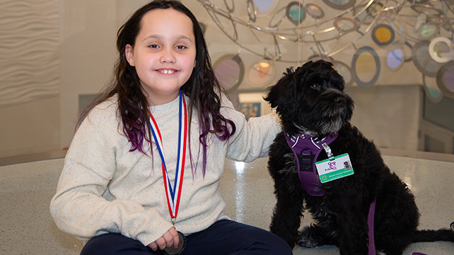 champion child London with therapy dog Cora
