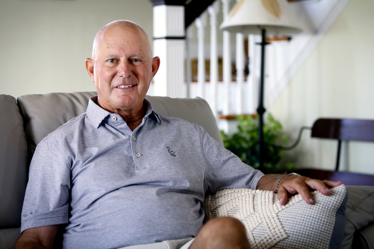Tom Cioffi relaxes on a couch in his living room at home.