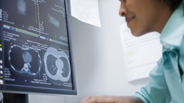 Medical staff looking at a computer monitor